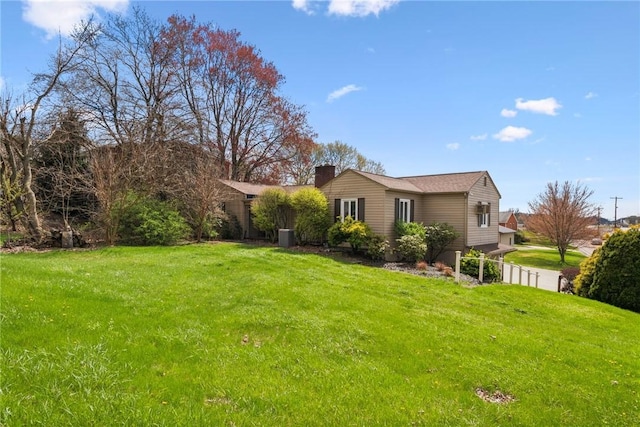 401 Pellis Rd, Hempfield Twp Wml, PA 15601 - view of side of property with fence, a chimney, and a lawn