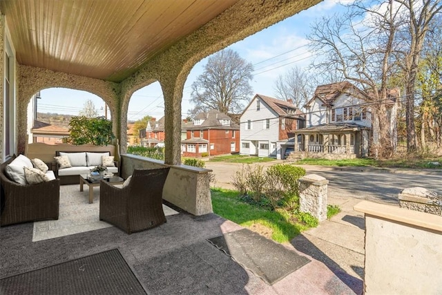 view of patio with a residential view and an outdoor living space