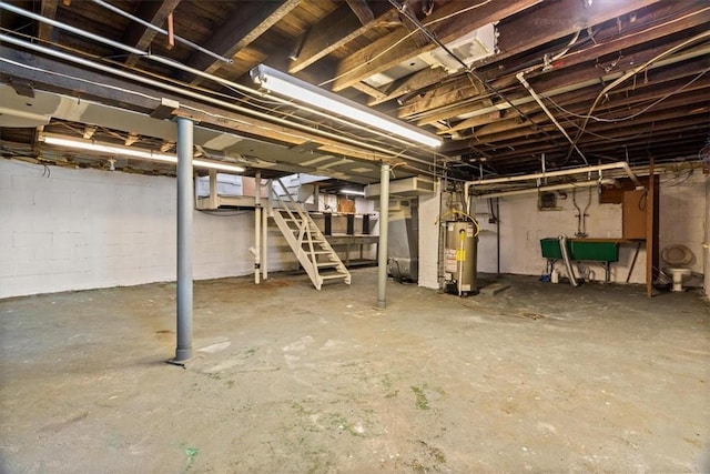 unfinished basement with water heater and stairway