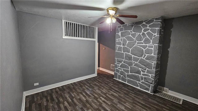 empty room featuring baseboards, ceiling fan, and wood finished floors