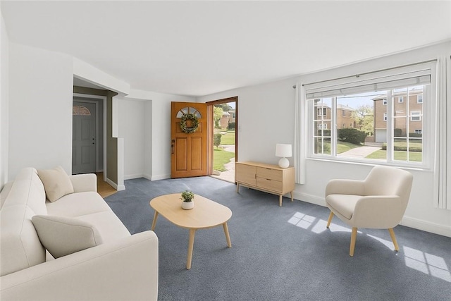 carpeted living room with baseboards