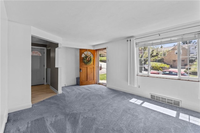 interior space with baseboards, carpet, and visible vents