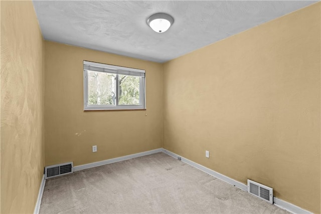 unfurnished room featuring visible vents, baseboards, and carpet floors