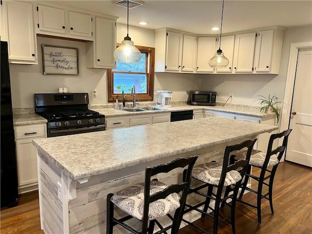 kitchen featuring a sink, dark wood-style flooring, black appliances, and white cabinets