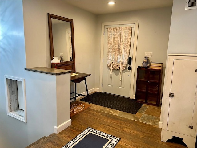 foyer with recessed lighting, baseboards, visible vents, and dark wood finished floors