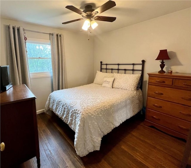 bedroom featuring ceiling fan and dark wood-style floors