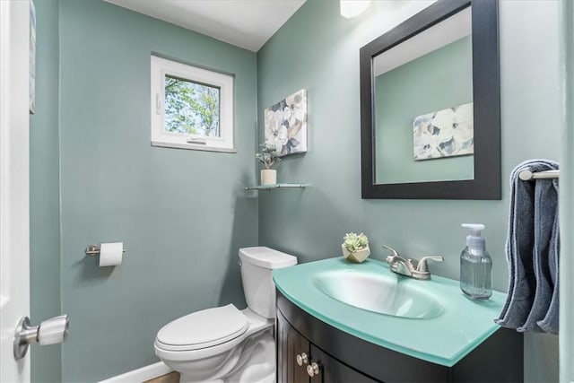half bathroom featuring toilet and vanity