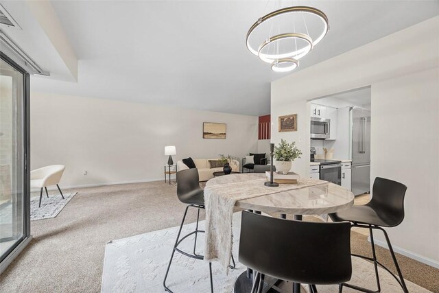 307 S Dithridge Unit 208, Oakland, PA 15213 - dining room featuring light carpet, baseboards, and a chandelier