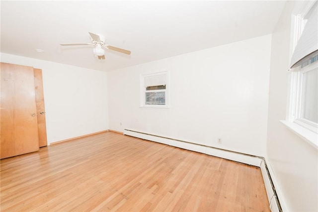 empty room with light wood-style floors and a ceiling fan