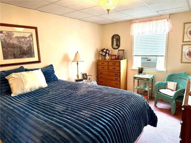 carpeted bedroom with a drop ceiling and cooling unit