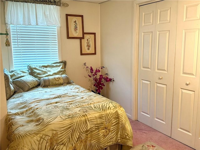 carpeted bedroom with a closet