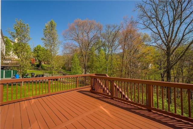 wooden terrace featuring a lawn