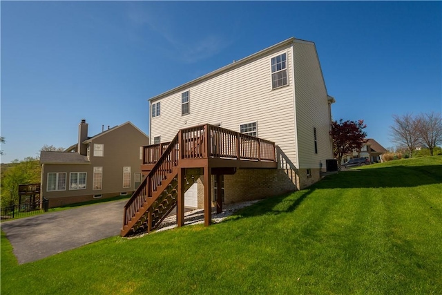 back of property featuring a lawn, central AC unit, a deck, and stairway