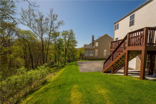 view of yard with stairs, a patio area, and a wooden deck