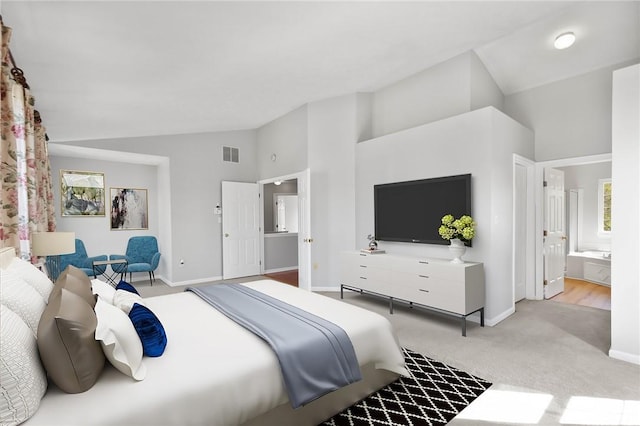 carpeted bedroom featuring visible vents, baseboards, ensuite bath, and high vaulted ceiling