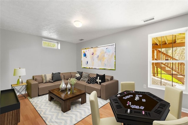 living area with light wood-type flooring and visible vents