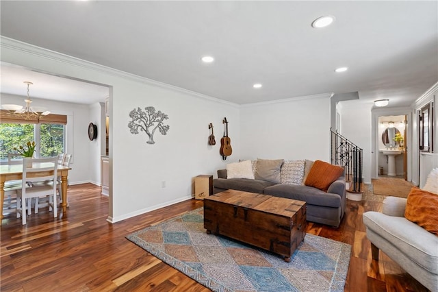 living area featuring crown molding, stairs, dark wood-style floors, an inviting chandelier, and recessed lighting