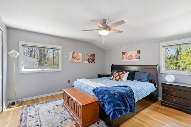 bedroom with baseboards, lofted ceiling, wood finished floors, and ceiling fan