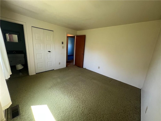 unfurnished bedroom with visible vents and a closet