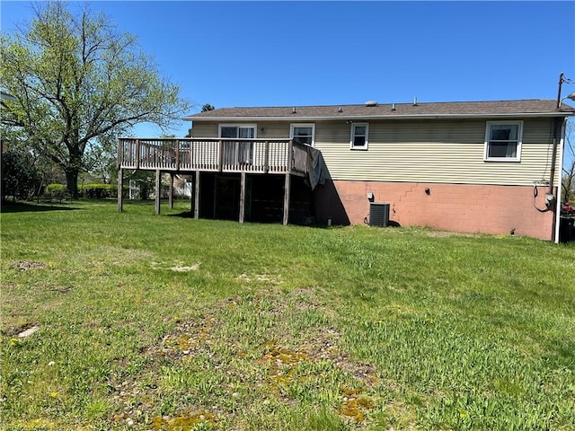 back of house featuring a lawn, a deck, and cooling unit