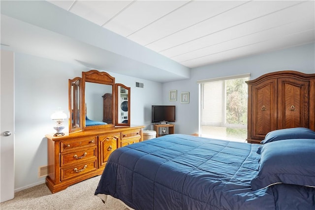 bedroom featuring baseboards, light colored carpet, and visible vents