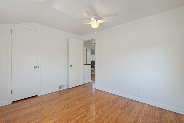 unfurnished bedroom with a ceiling fan, baseboards, visible vents, and light wood-type flooring