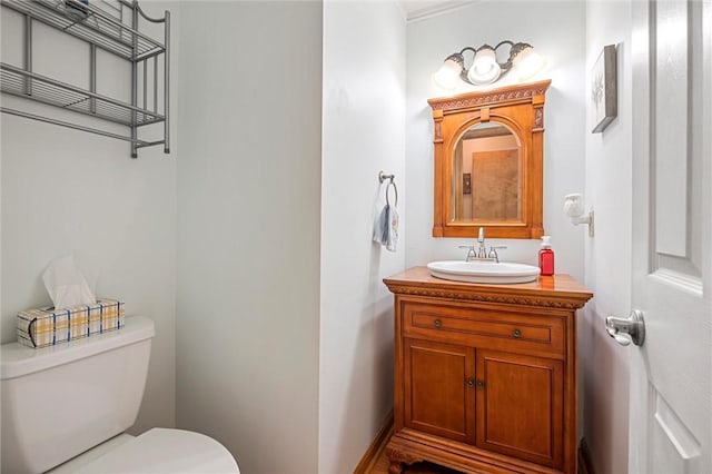 half bath with vanity and toilet