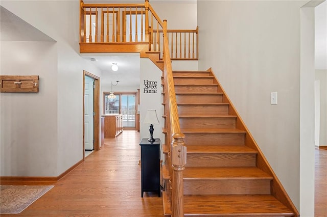 stairway featuring baseboards and wood finished floors