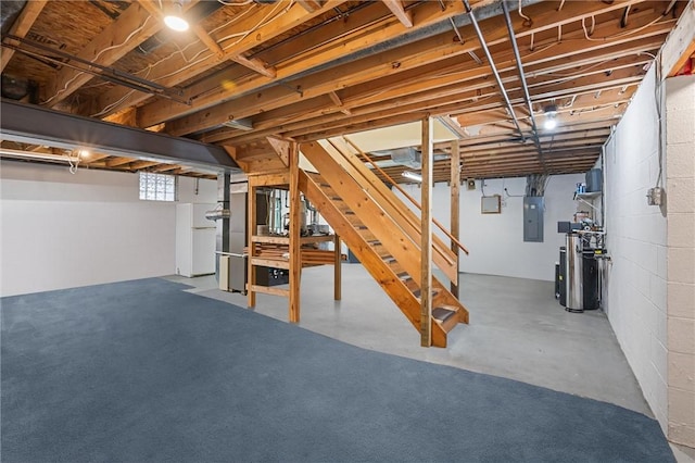 below grade area featuring heating unit, stairs, and electric panel