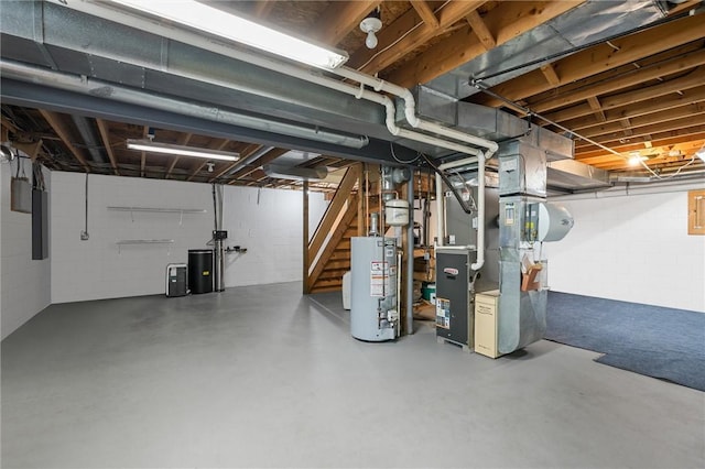 unfinished below grade area featuring heating unit, gas water heater, and stairway