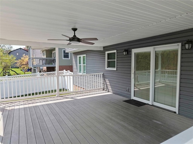 wooden deck featuring a ceiling fan