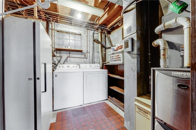 laundry room with separate washer and dryer, laundry area, and tile patterned flooring