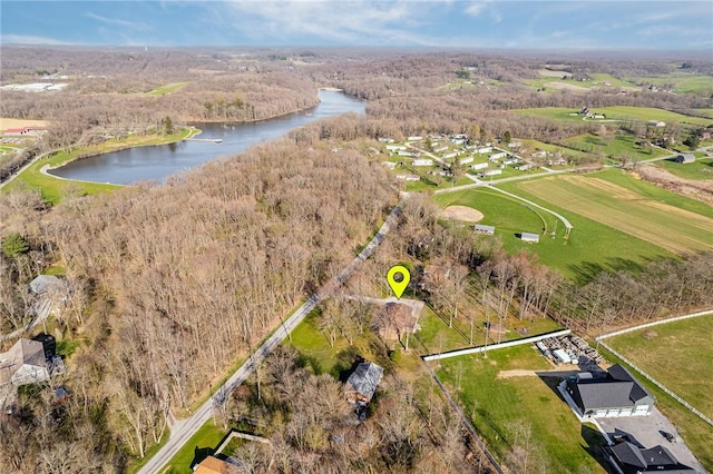 drone / aerial view featuring a water view and a forest view