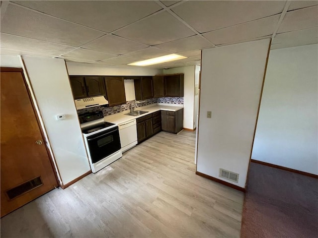 kitchen featuring baseboards, a sink, electric stove, and light countertops