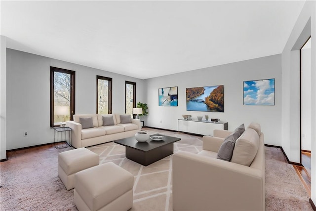 carpeted living area with baseboards