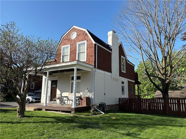 315 Taylor Ave, Bellevue, PA 15202 - rear view of house with fence, a chimney, a lawn, and a gambrel roof