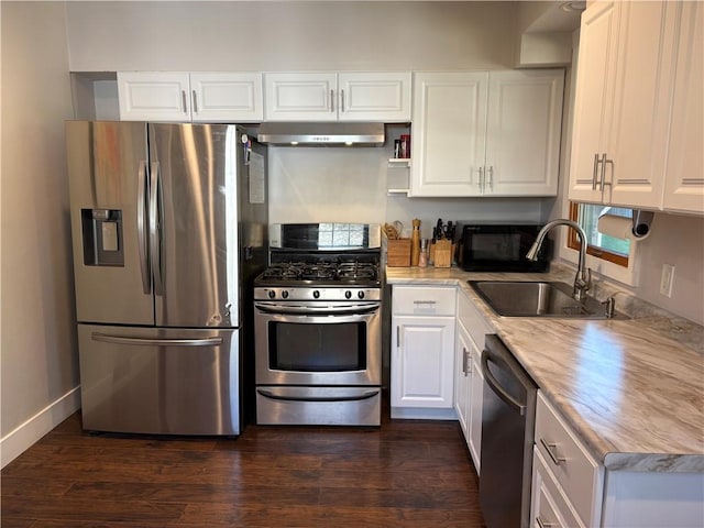 315 Taylor Ave, Bellevue, PA 15202 - kitchen featuring dark wood-style flooring, appliances with stainless steel finishes, a sink, under cabinet range hood, and white cabinetry