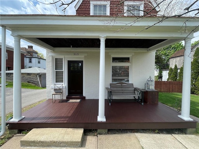 315 Taylor Ave, Bellevue, PA 15202 - property entrance with fence, a porch, and brick siding