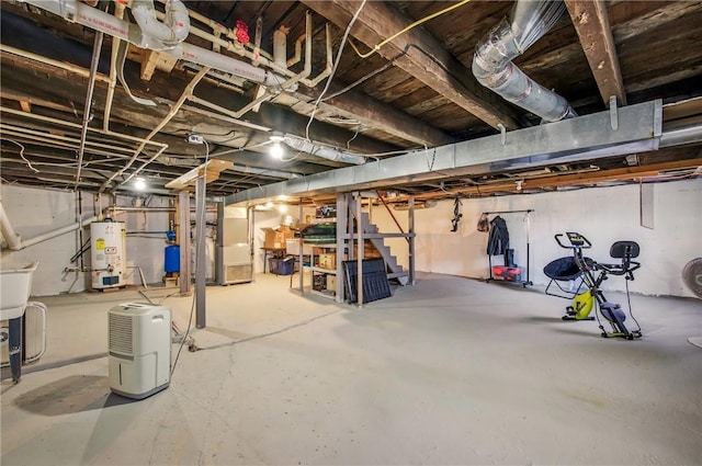 unfinished below grade area with stairs, heating unit, and gas water heater