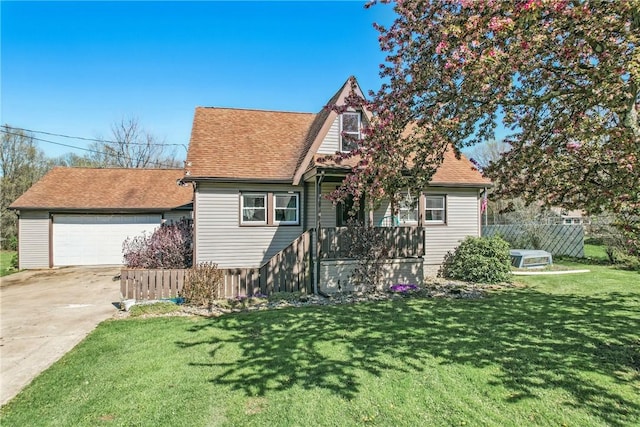 english style home with a garage, fence, a front lawn, concrete driveway, and a shingled roof