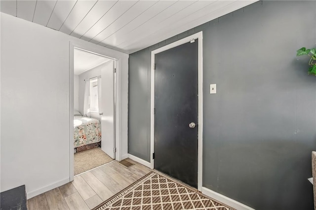 foyer featuring baseboards and light wood-style floors