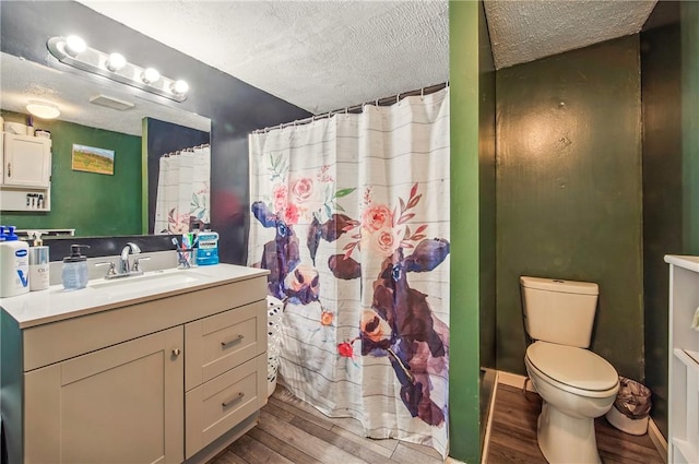 full bath featuring vanity, wood finished floors, toilet, a shower with shower curtain, and a textured ceiling