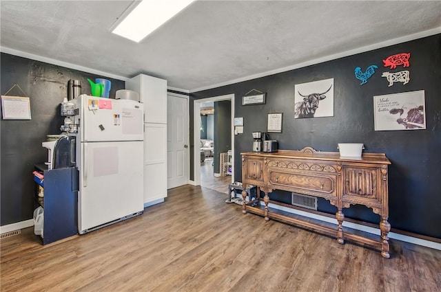 misc room with baseboards and light wood finished floors