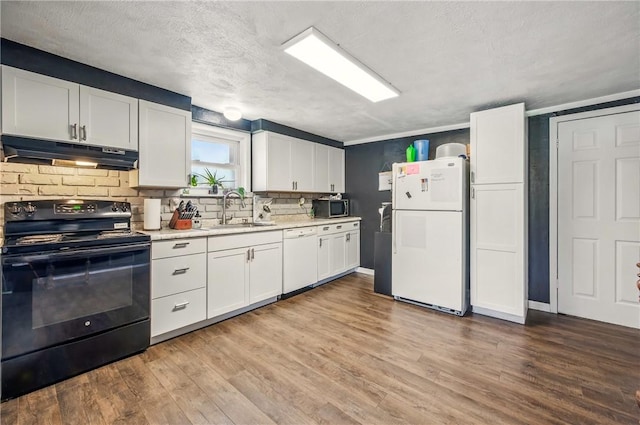kitchen featuring a sink, white appliances, light countertops, light wood-style flooring, and under cabinet range hood