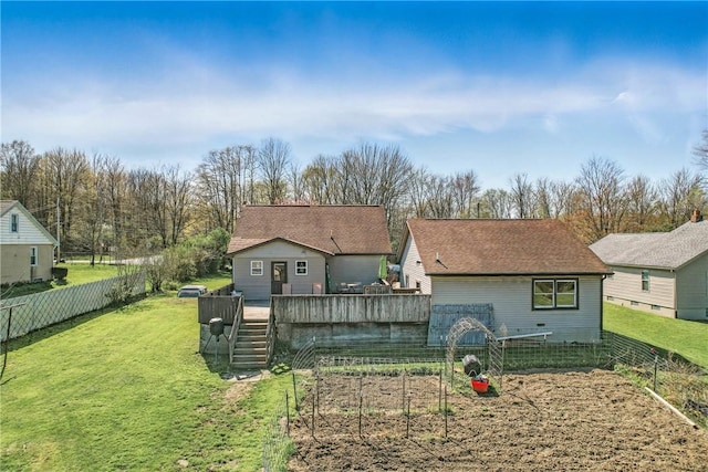 rear view of property with a lawn, stairway, a wooden deck, and a fenced backyard