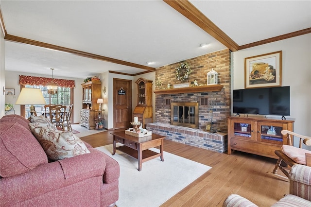 1058 Rimrock Rd, City Of Greensburg, PA 15601 - living area with crown molding, a notable chandelier, beam ceiling, a brick fireplace, and wood finished floors