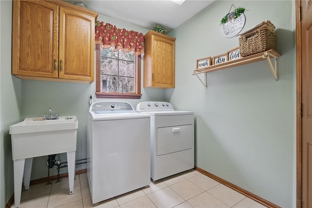 1058 Rimrock Rd, City Of Greensburg, PA 15601 - laundry room with cabinet space, baseboards, light tile patterned floors, and washing machine and clothes dryer