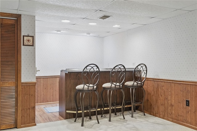 1058 Rimrock Rd, City Of Greensburg, PA 15601 - bar with wooden walls, a dry bar, a paneled ceiling, and a wainscoted wall