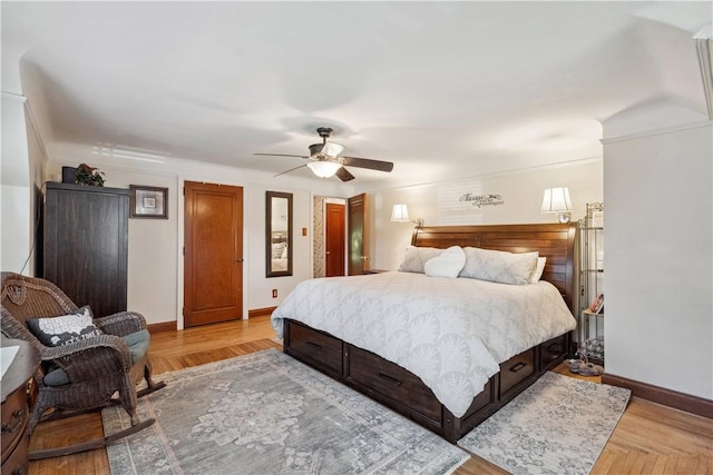 bedroom with baseboards, ceiling fan, and light wood-style floors