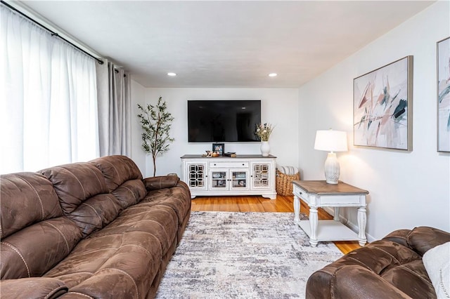 living area with recessed lighting and wood finished floors